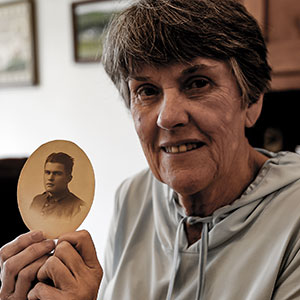 Retired nursing Professor Eileen Kinsella holds a photo of her grandfather, Leonard Cunningham ’15, taken when he entered the Army during World War I.