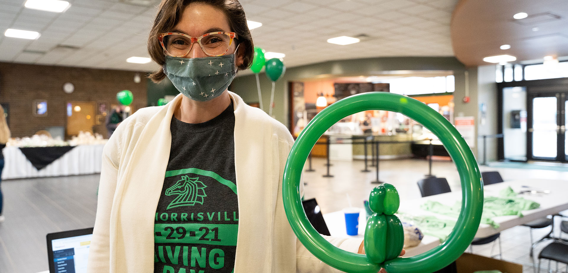 Theresa Kevorkian, vice president for institutional advancement, displays one of her balloon creations during Giving Day