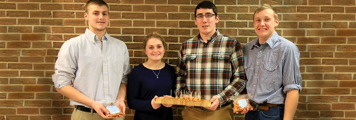 Ag business students pose with a food product they created.