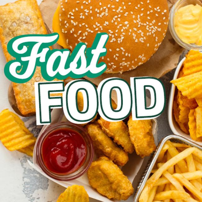 Variety of fast food: Cheeseburger, french fries, chicken nuggets & ketchup