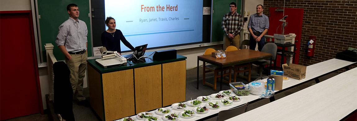 Ag business students give a presentation on a food product they created.