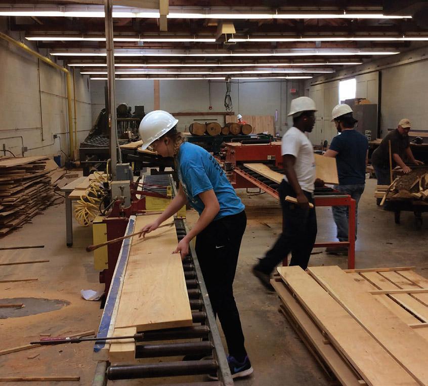 Multiple students work in the Wood Products Technology Center