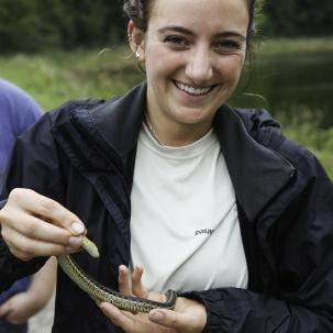 Kate Augustine holds a garter snake. Augustine is a renewable resources technology bachelor degree student from Saranac Lake.
